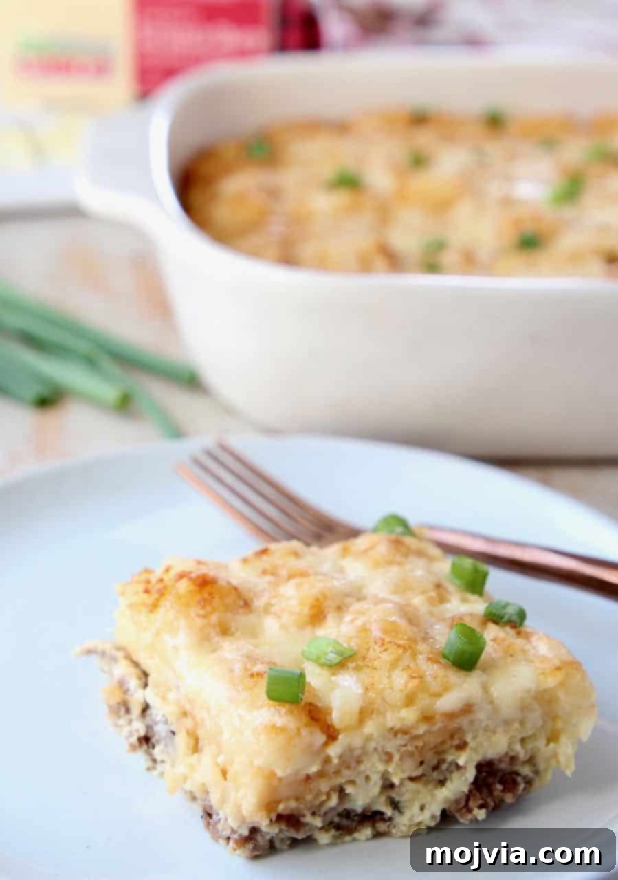 Golden Cheesy Tater Tot Bake 5 Slice of breakfast tater tot casserole on plate with fork