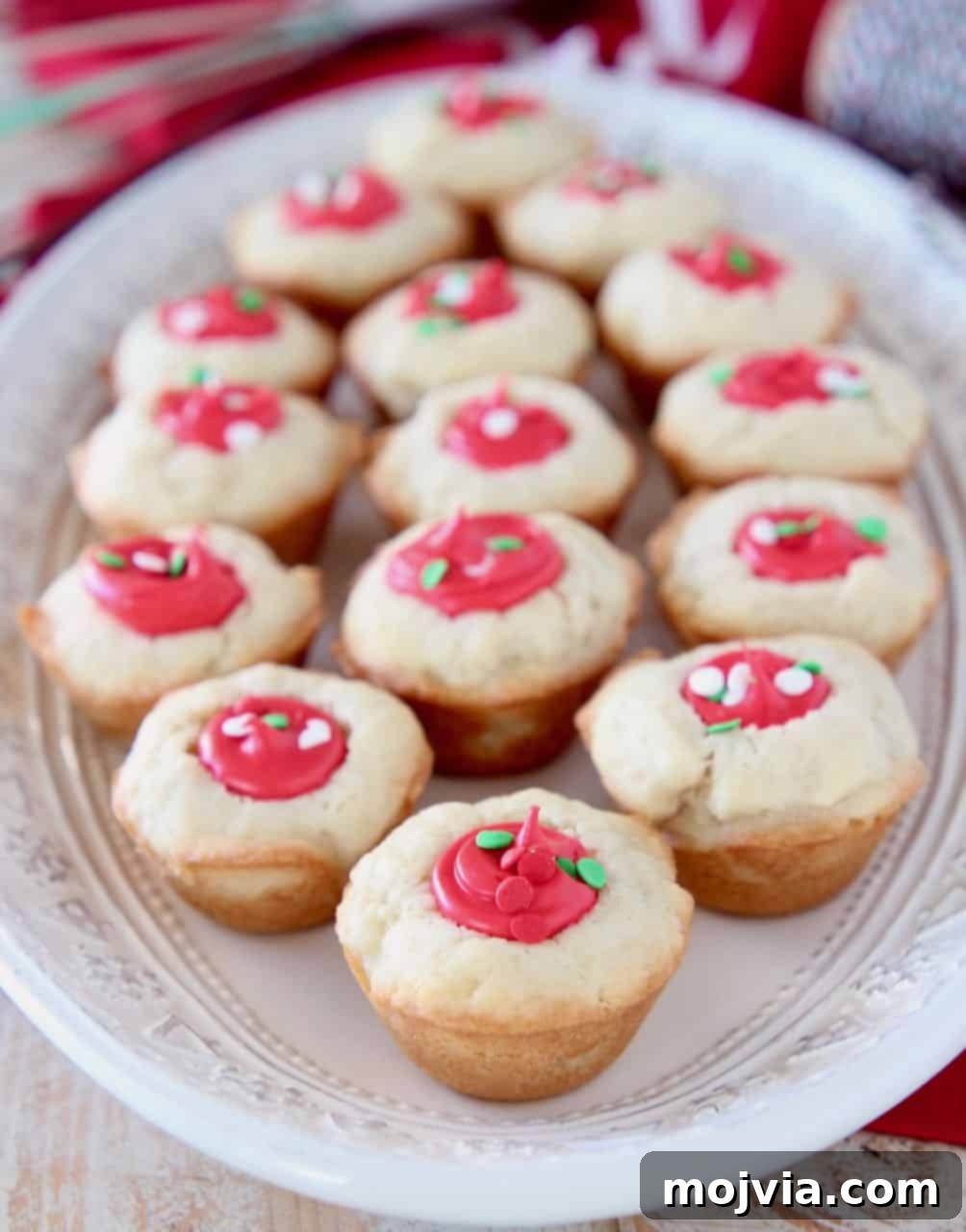 Creamy-Filled Sugar Cookie Cups 2 Sugar cookie cups filled with red frosting on white plate