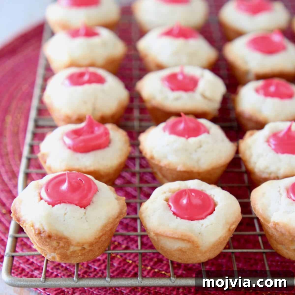 Creamy-Filled Sugar Cookie Cups 3 Sugar cookie cups with red frosting filling sitting on wire rack