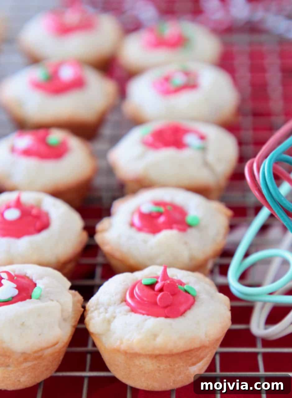 Creamy-Filled Sugar Cookie Cups 5 Sugar cookie cups with red frosting filling sitting on wire rack