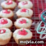 Creamy-Filled Sugar Cookie Cups 6 Sugar cookie cups with red frosting filling sitting on wire cooling rack
