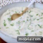 Creamy Cauliflower Mash 9 Creamy mashed cauliflower in a bowl with a spoon