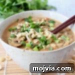 One Pot Creamy Thai Peanut Noodle Soup 5 Noodle soup in bowl with brown chopsticks