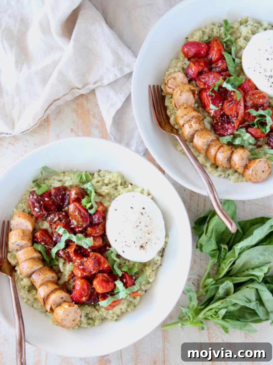 Creamy Instant Pot Pesto Risotto 3 A vibrant bowl of Instant Pot Pesto Risotto, garnished with freshly roasted cherry tomatoes, expertly sliced Italian sausage, and a generous dollop of rich burrata cheese