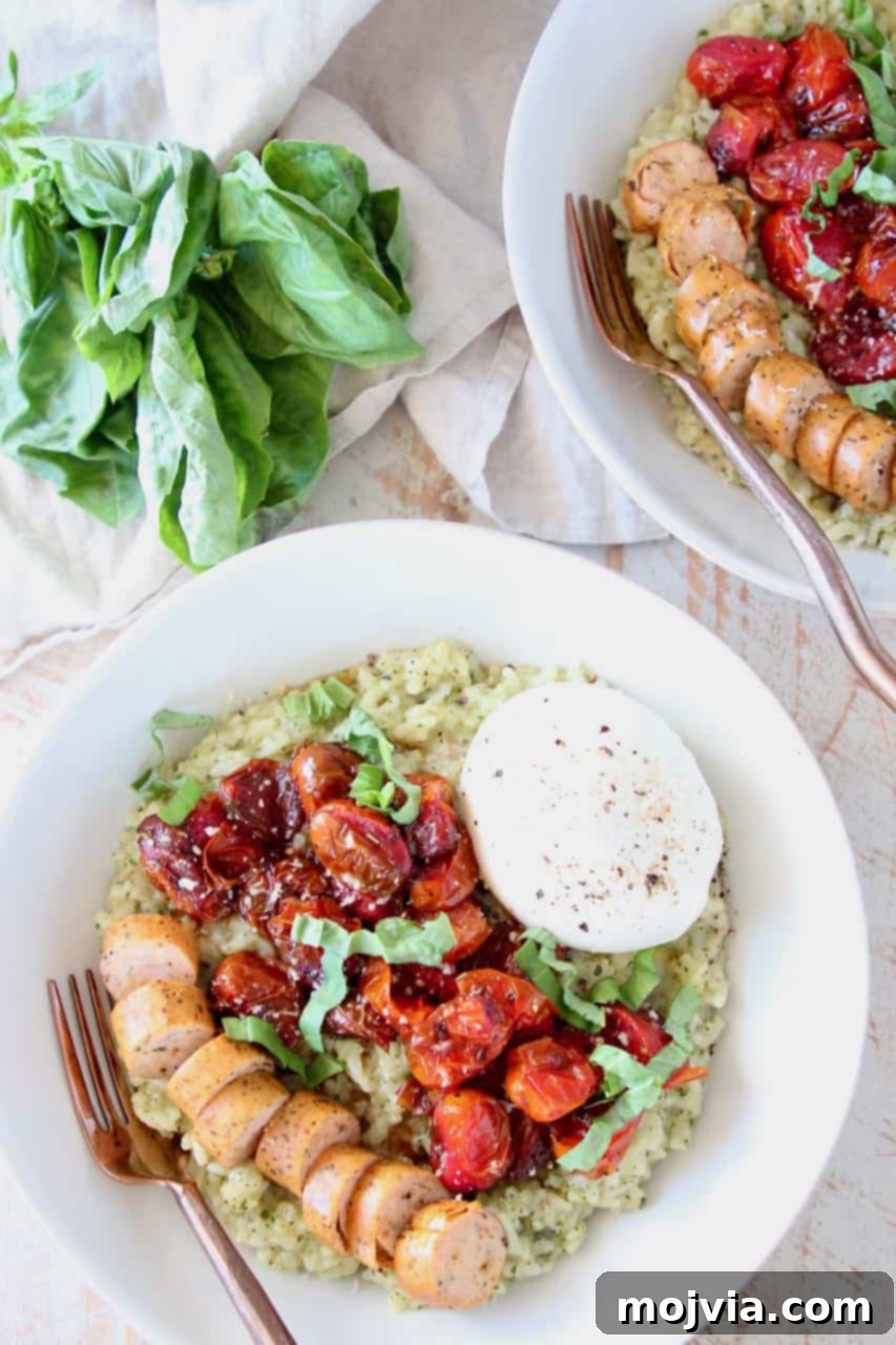 Creamy Instant Pot Pesto Risotto 4 A close-up shot of creamy Pesto Risotto in a bowl, generously topped with slices of roasted Italian sausage, vibrant cherry tomatoes, and a dollop of fresh burrata cheese, ready to be enjoyed