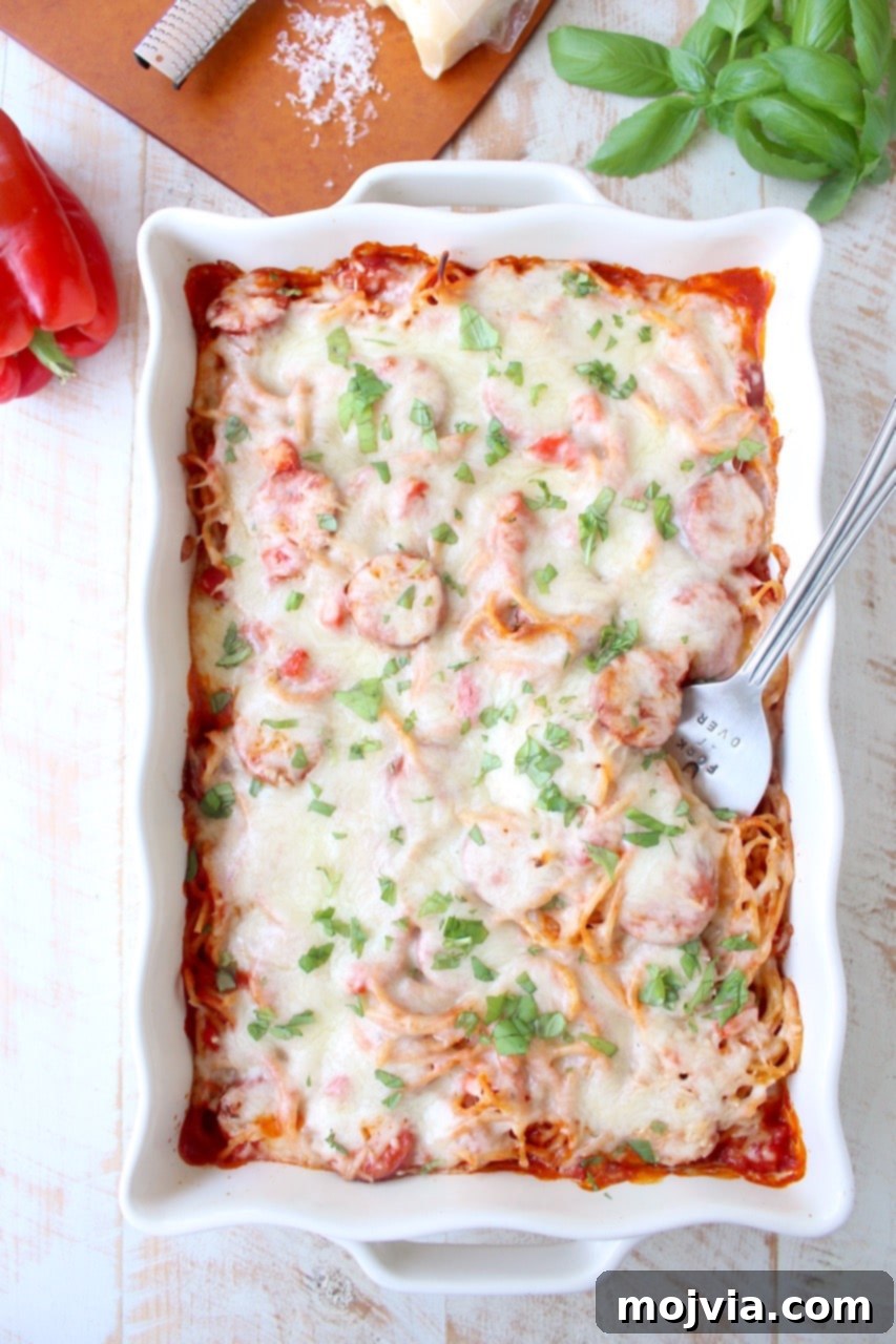 Pantry Power: Simple Recipes and Your Shopping List 13 Easy Pizza Baked Spaghetti recipe topped with sausage, peppers, and melted cheese