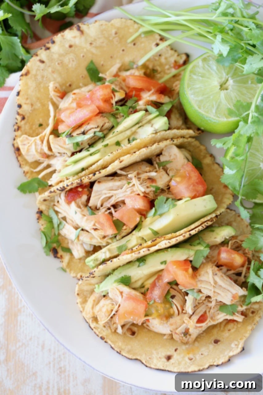 Pantry Power: Simple Recipes and Your Shopping List 16 Delicious shredded pressure cooker chicken tacos served in corn tortillas with cilantro and lime