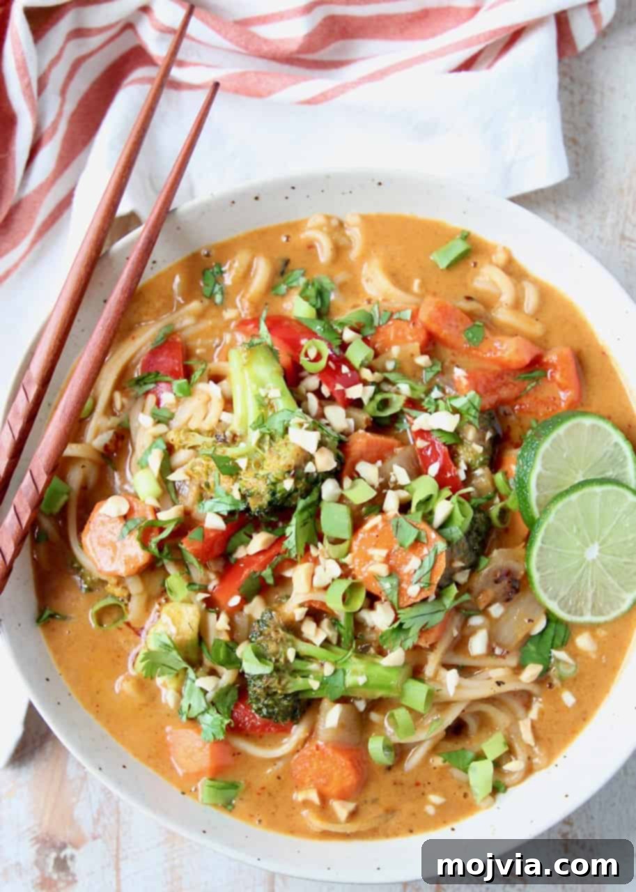 Overhead images of massaman curry sauce with vegetables and noodles in bowl, with chopsticks on the side