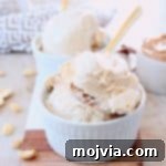 Creamy No-Churn Peanut Butter Ice Cream 6 Scoops of peanut butter ice cream in white bowls with gold spoons