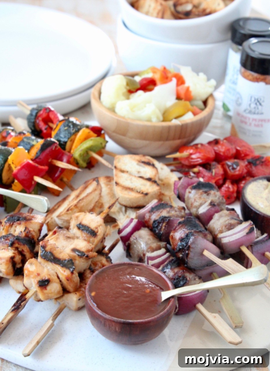 Grilled Bites Charcuterie Board 2 Grilled mini skewers, melted brie, and various sauces on a beautifully arranged charcuterie board