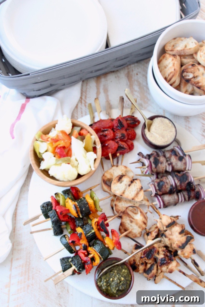 Grilled Bites Charcuterie Board 9 A beautifully presented grilled charcuterie board with mini skewers, baguette, sauces, and a basket of napkins for a summer gathering