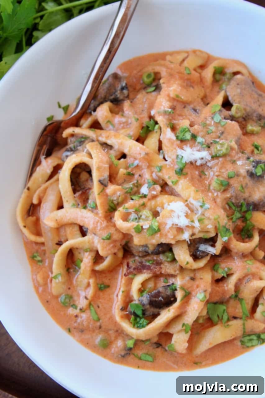 Pasta Boscaiola: Creamy Forest Mushrooms & Smoked Bacon 2 Overhead image of pasta in creamy tomato mushroom sauce