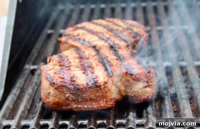 10 Game-Changing Grilling Secrets 4 Tenderloin steaks beautifully seared on the grill, showing perfect grill marks and even cooking.