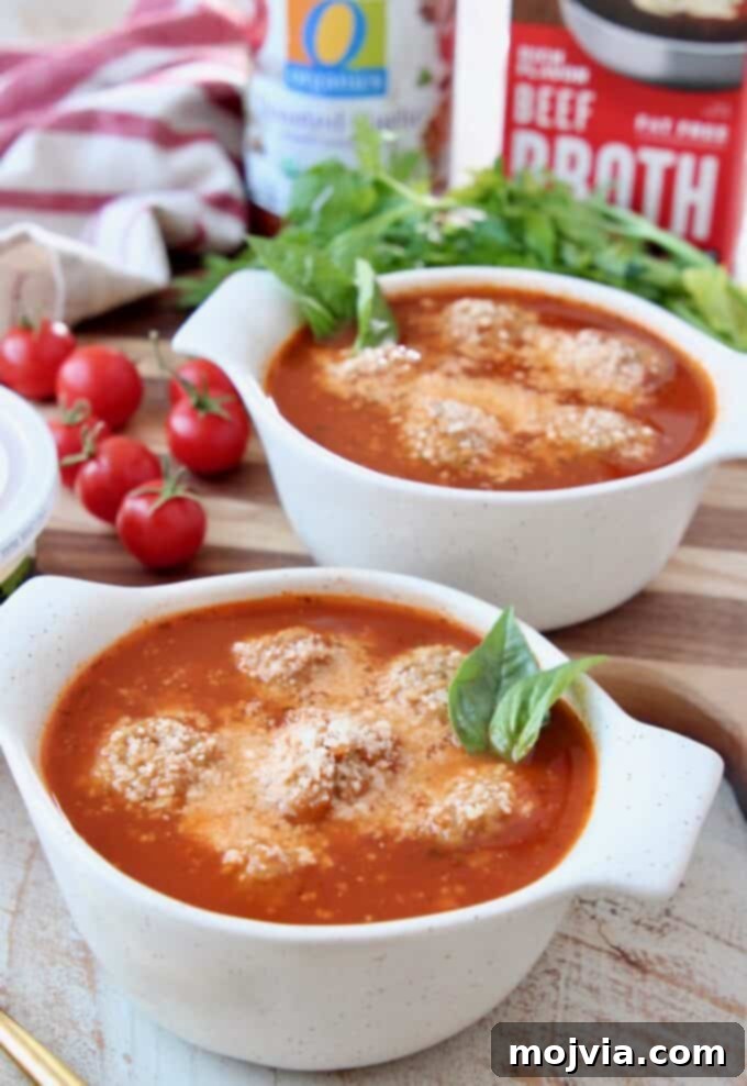 Five-Ingredient Italian Meatball Magic 5 meatball soup in bowls topped with grated parmesan cheese and fresh basil leaves