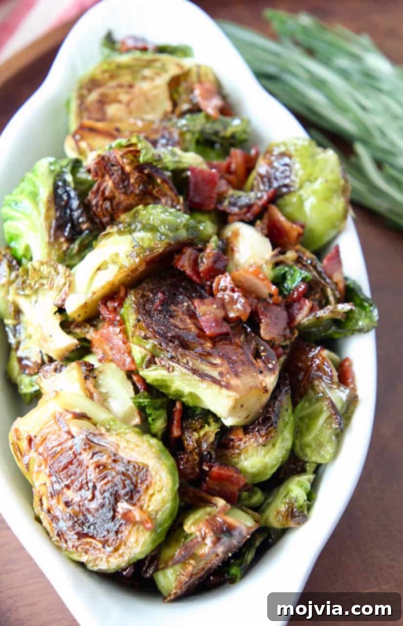 Roasted Maple Bacon Brussels Sprouts 5 cooked brussels sprouts and bacon in white serving dish