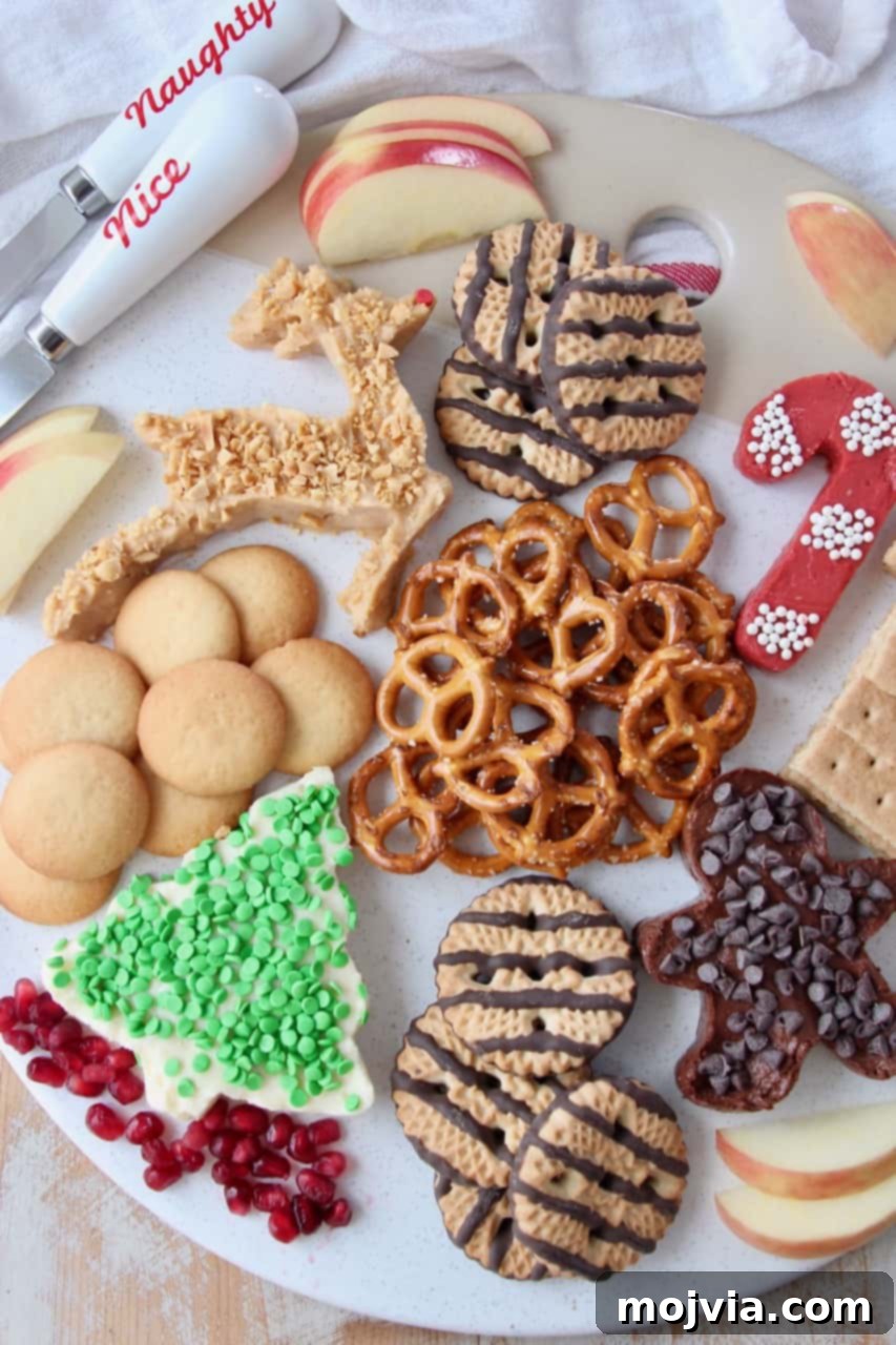 Festive Dessert Platter with Dreamy Cream Cheese Dip 2 overhead image of dessert board with pretzels, cookies and cream cheese dip in holiday shapes