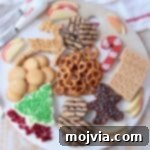 overhead image of holiday dessert board with cream cheese dips