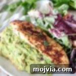 guacamole stuffed chicken on plate with salad