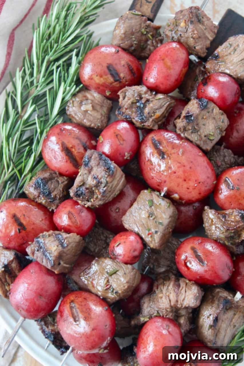 Montreal Steak Spice 4 Succulent sirloin steak and tender baby potatoes artfully arranged on skewers, stacked on a plate, seasoned to perfection.