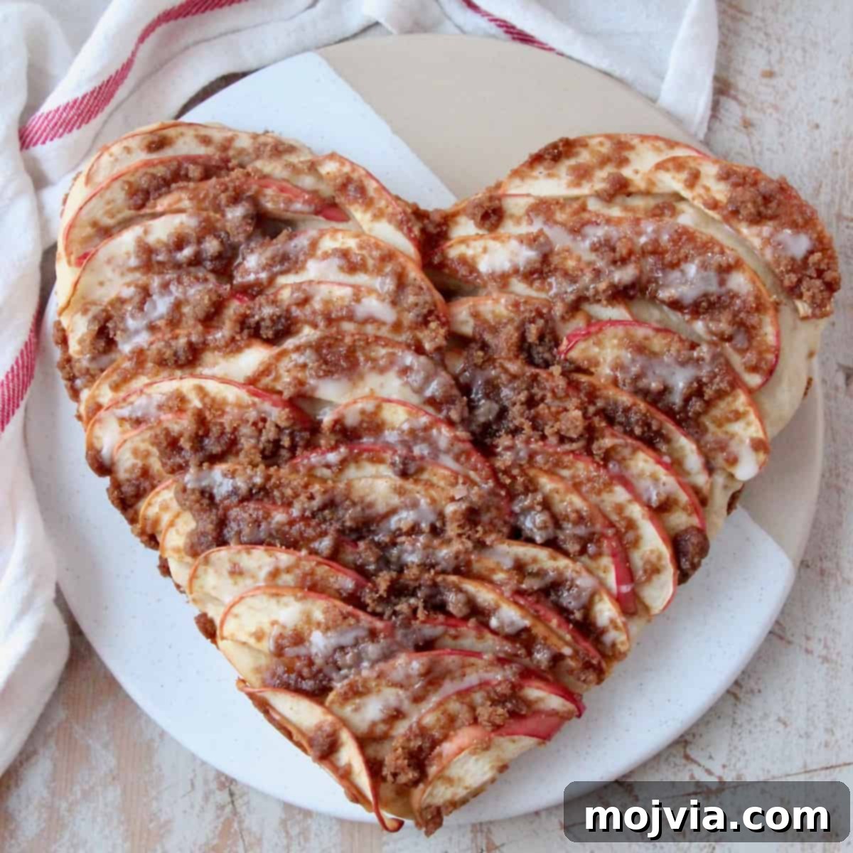 Cinnamon Streusel Apple Dessert Pizza 7 Overhead image of a beautifully presented heart-shaped apple dessert pizza, perfect for Valentine's Day.