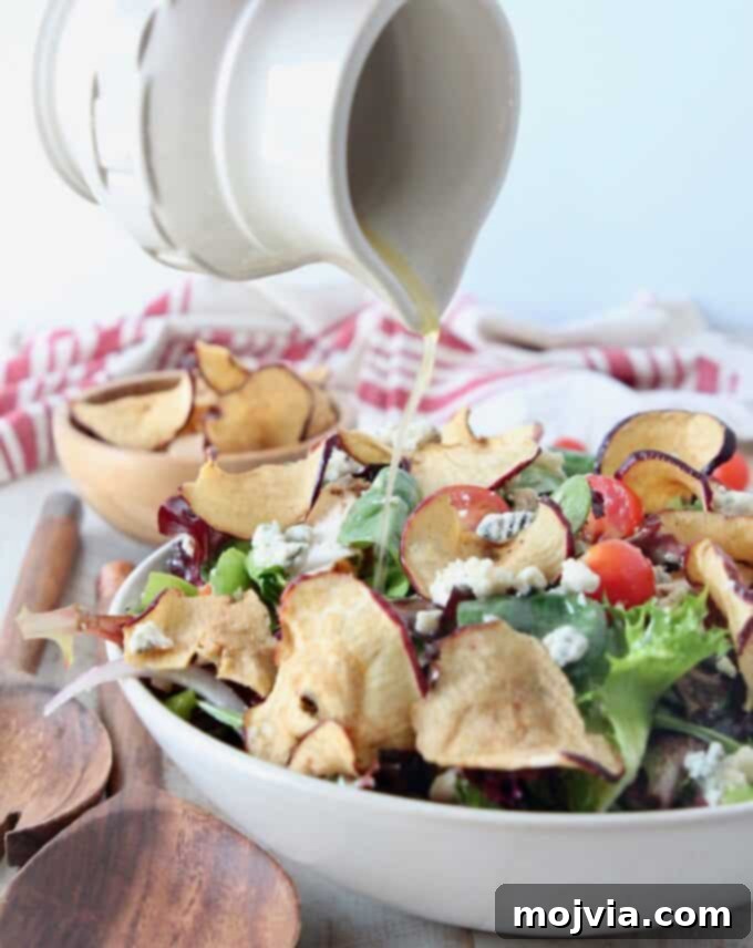Bright Fuji Apple Dressing 2 Small pitcher pouring homemade Fuji Apple Salad Dressing onto a vibrant salad in a glass bowl