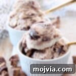 Decadent No-Churn Moose Tracks Delight 7 scoops of moose tracks ice cream in white bowls with gold spoons