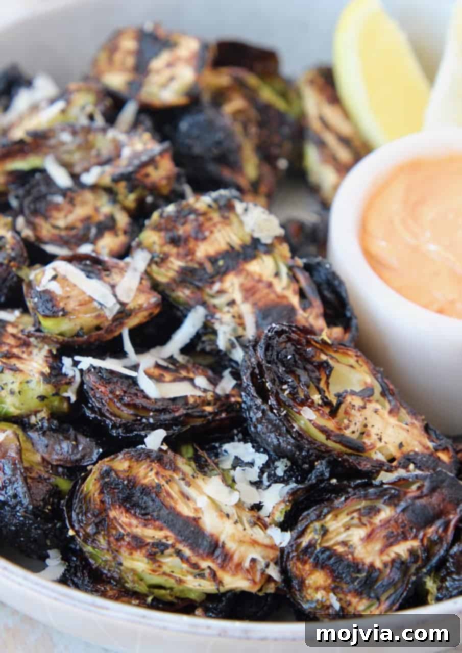 Fire-Kissed Brussels Sprouts 6 grilled brussels sprouts in bowl with dipping sauce