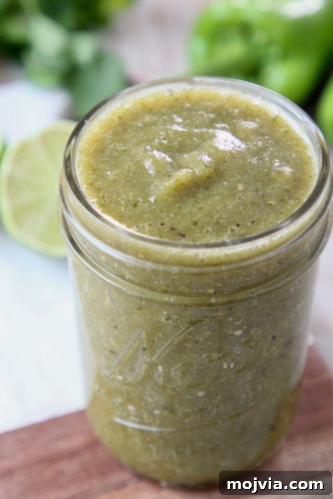 Vibrant Verde Enchilada Sauce 2 Homemade Green Enchilada Sauce in a mason jar, showcasing its fresh, vibrant color and texture.