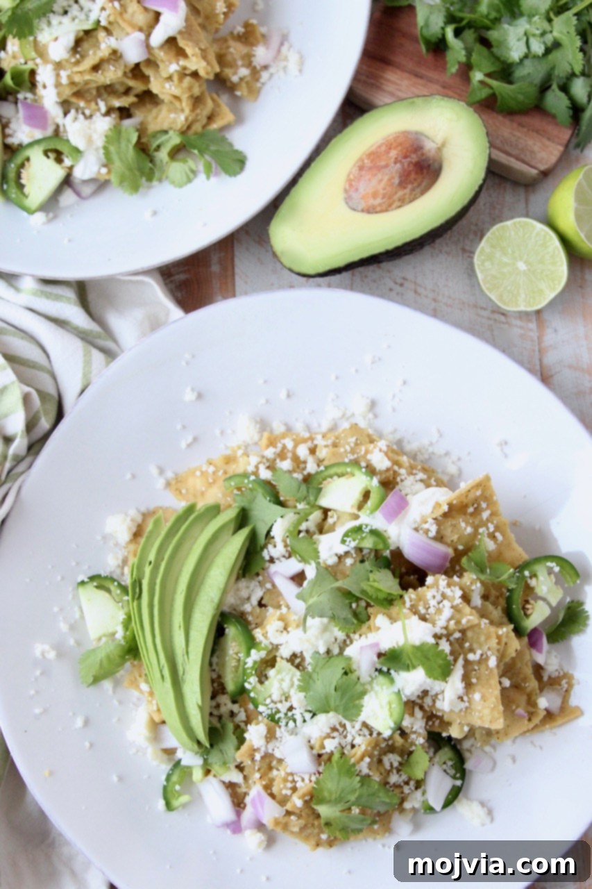 Zesty Verde Chilaquiles 2 A plate of Chilaquiles Verdes topped with fresh cilantro, diced avocado, and a sprinkle of cheese, ready to be enjoyed.