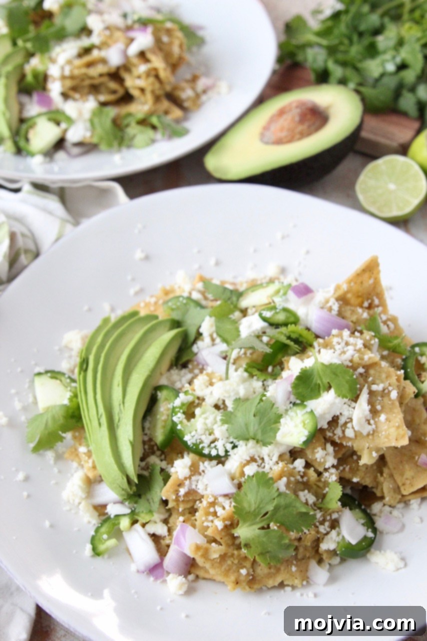 Zesty Verde Chilaquiles 5 A vibrant plate of Chilaquiles Verdes garnished with fresh cilantro and a generous sprinkle of Cotija cheese, showcasing the rich green sauce.