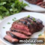 Sirloin Steak Marinade for Tender Perfection 9 sliced grilled steak on plate with fork