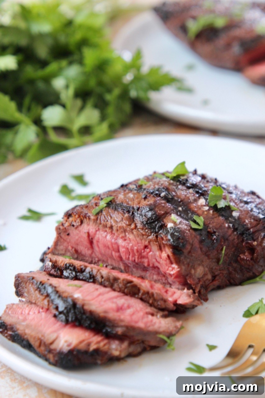 Sirloin Steak Marinade for Tender Perfection 6 sliced grilled sirloin steak on white plate