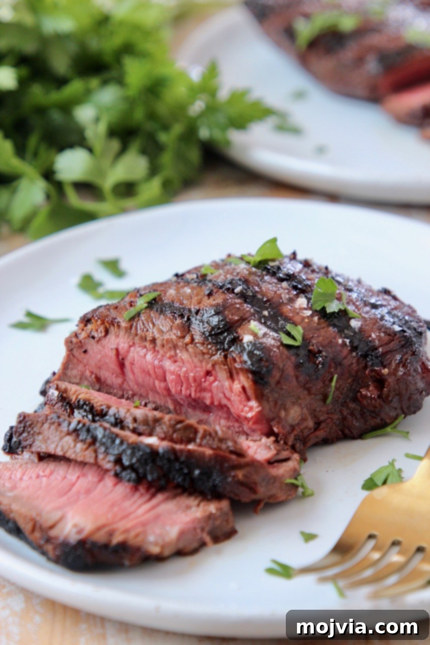Sirloin Steak Marinade for Tender Perfection 8 sliced sirloin steak on plate with fork