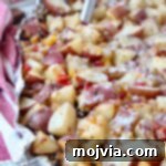 cheesy grilled cubed potatoes in foil with spatula