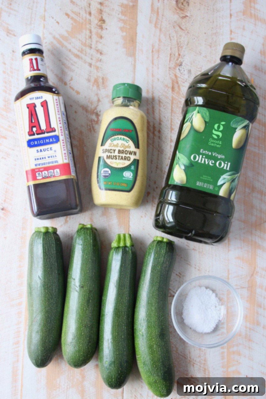 Summer Grilled Zucchini 3 Arrangement of fresh ingredients including zucchini, spicy brown mustard, A1 sauce, olive oil, and sea salt, ready for making the grilled zucchini marinade.