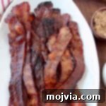 Pig Candy 7 cooked slices of bacon stacked up on plate
