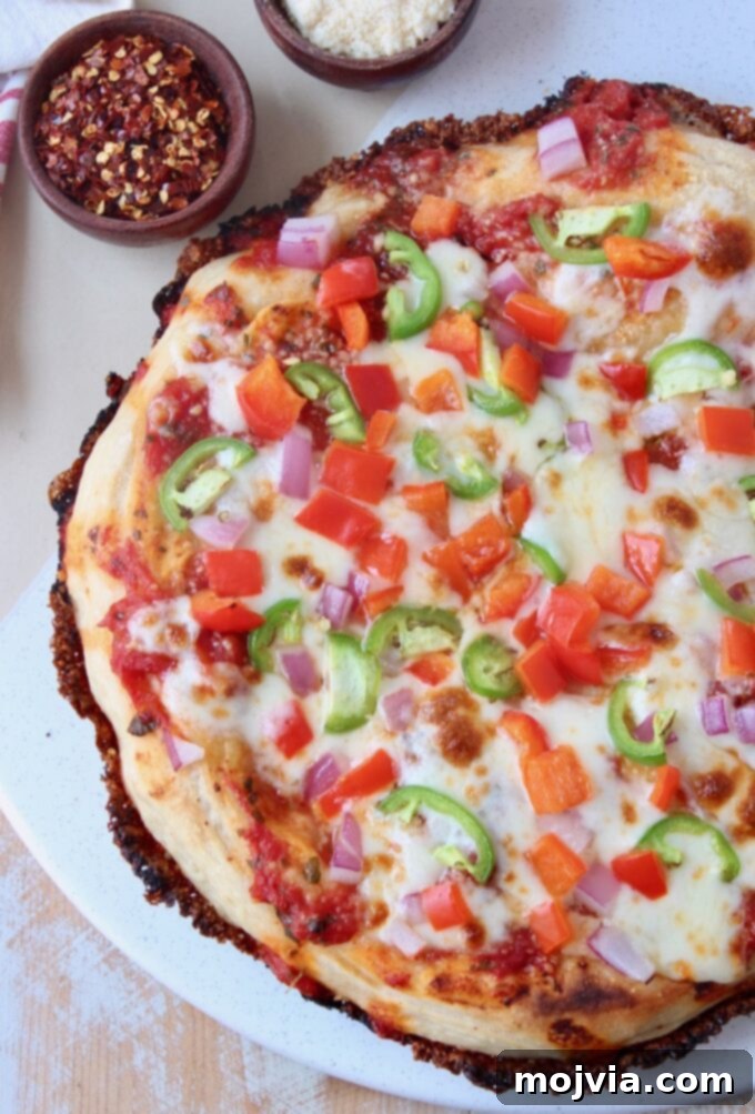 Kurt's Signature Pan Pizza 2 whole cooked pan pizza on marble serving tray with crispy cheese edges