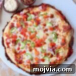 overhead image of cooked pan pizza on marble serving tray
