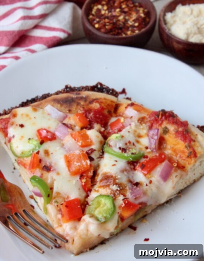 Kurt's Signature Pan Pizza 3 two delectable slices of pan pizza on a pristine white plate, showcasing the golden, crispy crust and rich toppings