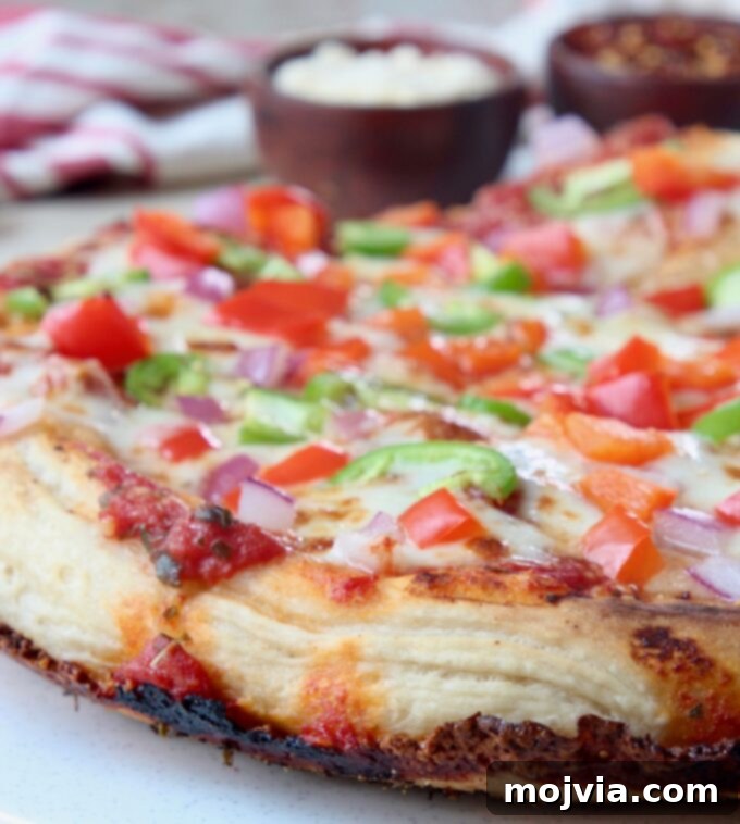 Kurt's Signature Pan Pizza 8 a mouth-watering pan pizza with a prominent crispy cheese crust and fresh vegetable toppings