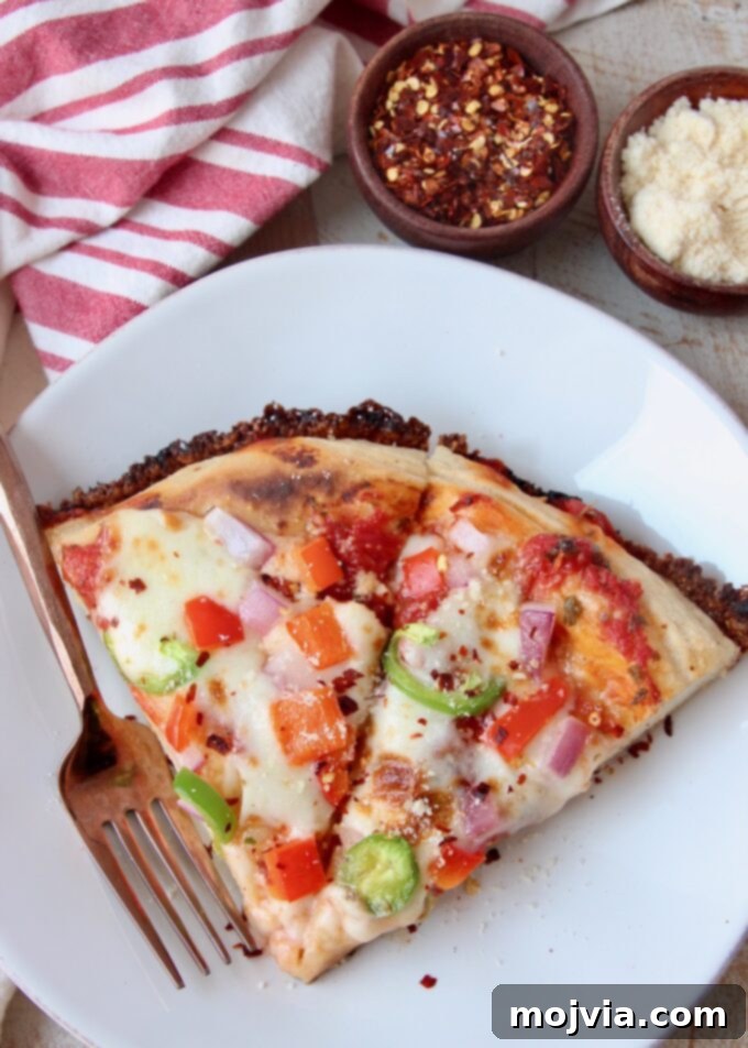 Kurt's Signature Pan Pizza 9 two perfectly golden slices of homemade pan pizza on a white plate, ready to be enjoyed with a fork