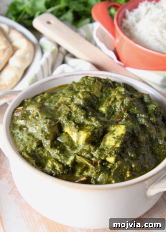 Spinach Paneer Curry 2 Delicious Palak Paneer in a white serving bowl, ready to be enjoyed.