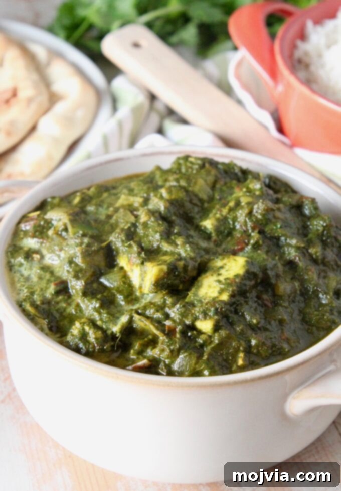 Spinach Paneer Curry 7 A generous serving of Palak Paneer in a white bowl, perfect for a vegetarian meal.