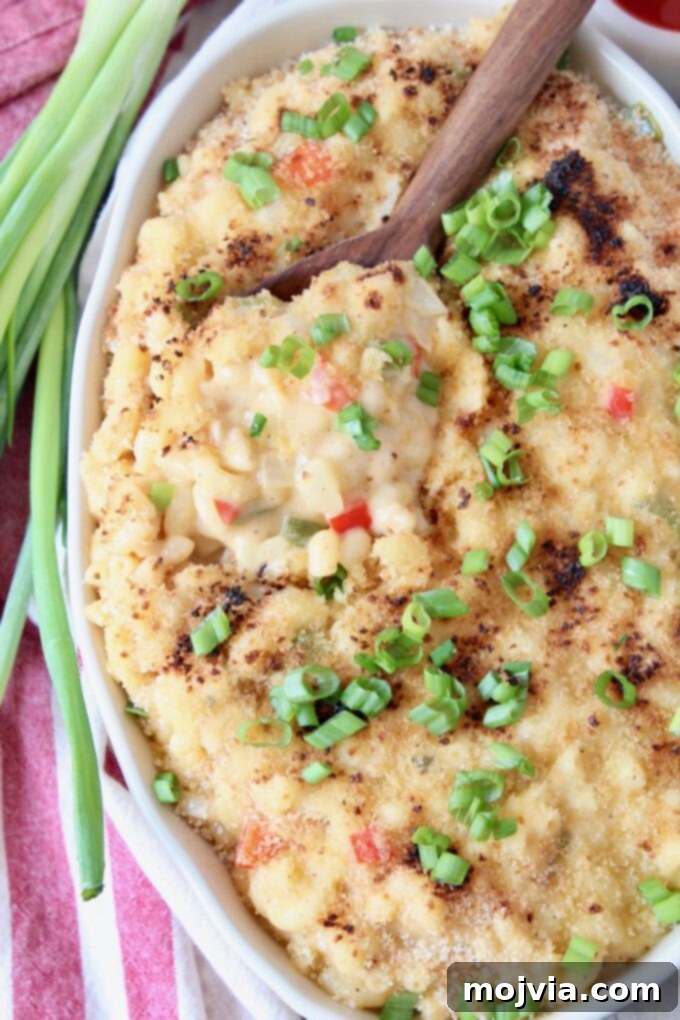 Bayou Blend Mac and Cheese 2 Large serving dish filled with creamy Cajun Mac and Cheese, ready to be served with a spoon. A perfect blend of comfort and spice.