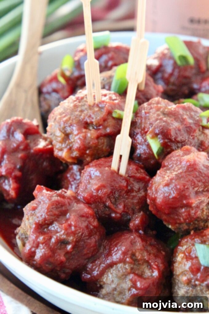 Red Wine Infused BBQ Beef Meatballs 8 bbq meatballs in bowl with toothpicks in the meatballs