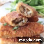 Crispy Cheeseburger Egg Rolls Air Fryer Pan Fry 9 cheeseburger egg rolls stacked up on plate