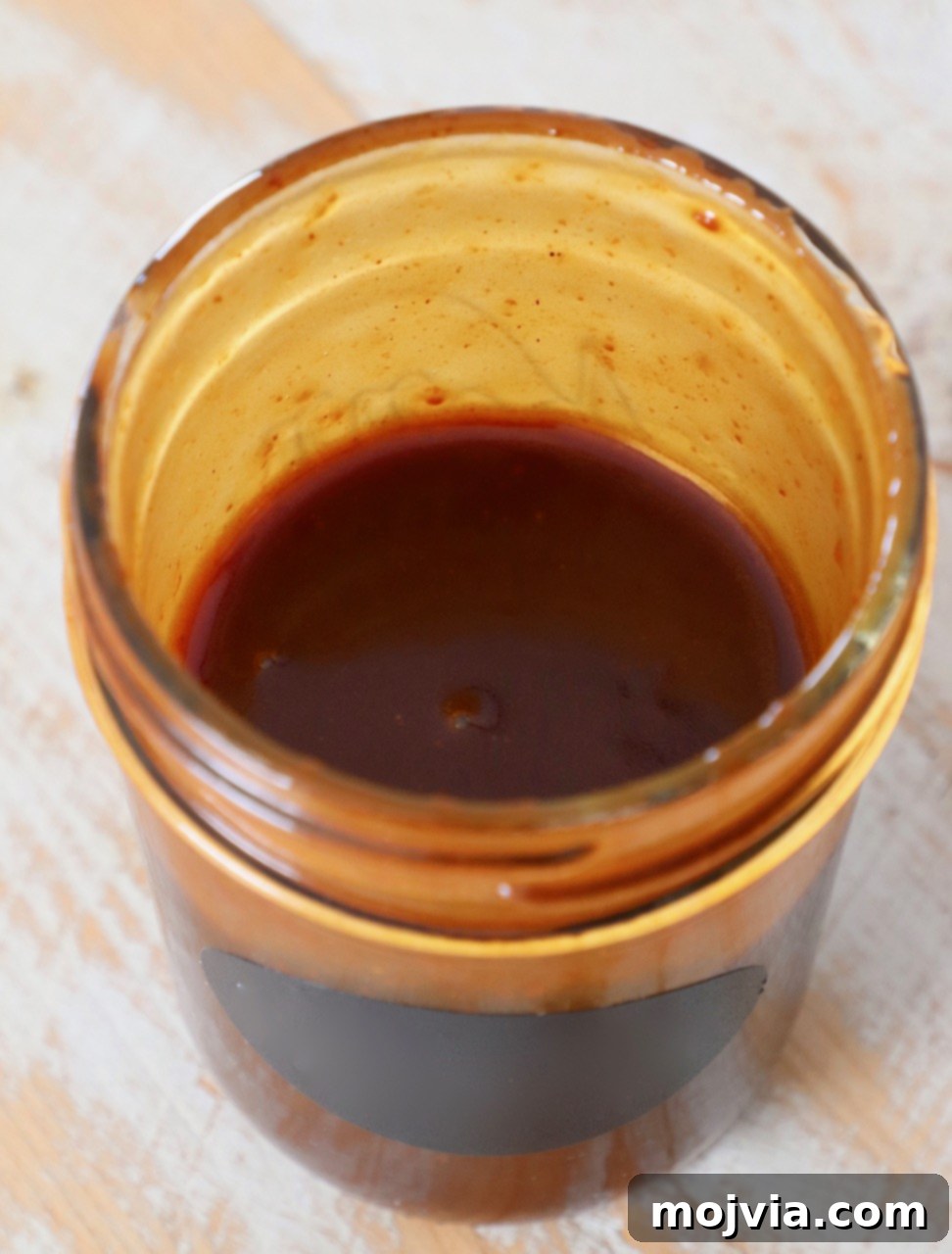 Perfect Stir-Fry Sauce 4 Homemade stir fry sauce stored in a small mason jar, showcasing its rich, deep brown color, ready to be used in future delicious stir-fry meals or as a marinade.