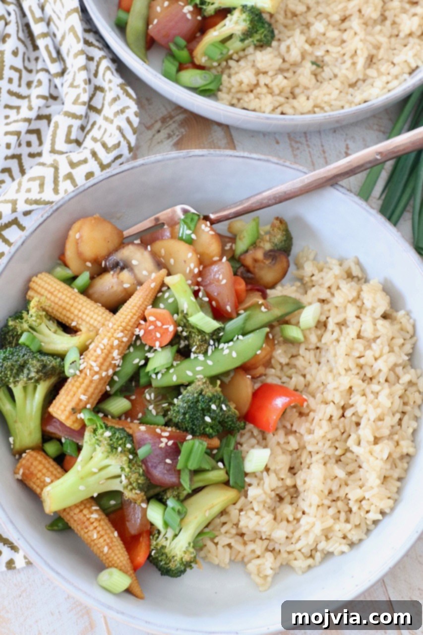 Vibrant Vegetable Stir-Fry 2 Vibrant stir fry vegetables in a bowl with brown rice, ready to be enjoyed with a fork