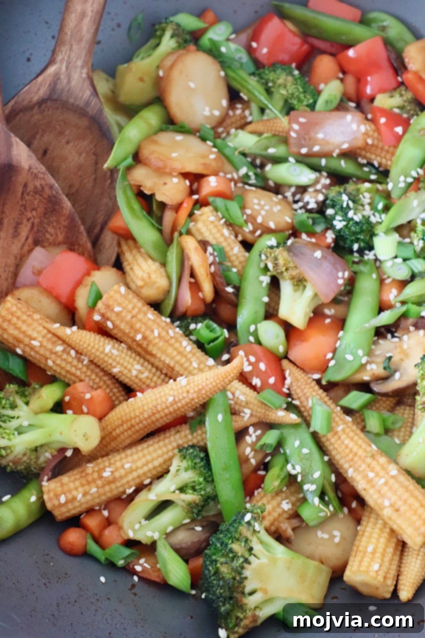Vibrant Vegetable Stir-Fry 4 Stir fry vegetables being tossed in a wok with a wooden spoon