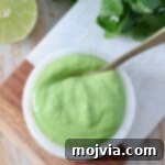 Bright Cilantro Lime Sauce 7 Cilantro lime sauce in a bowl with a spoon, ready to be served.